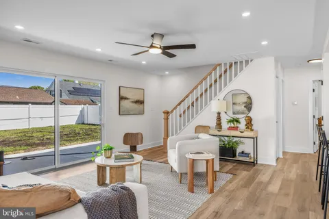 a living room with furniture a fireplace and a large window