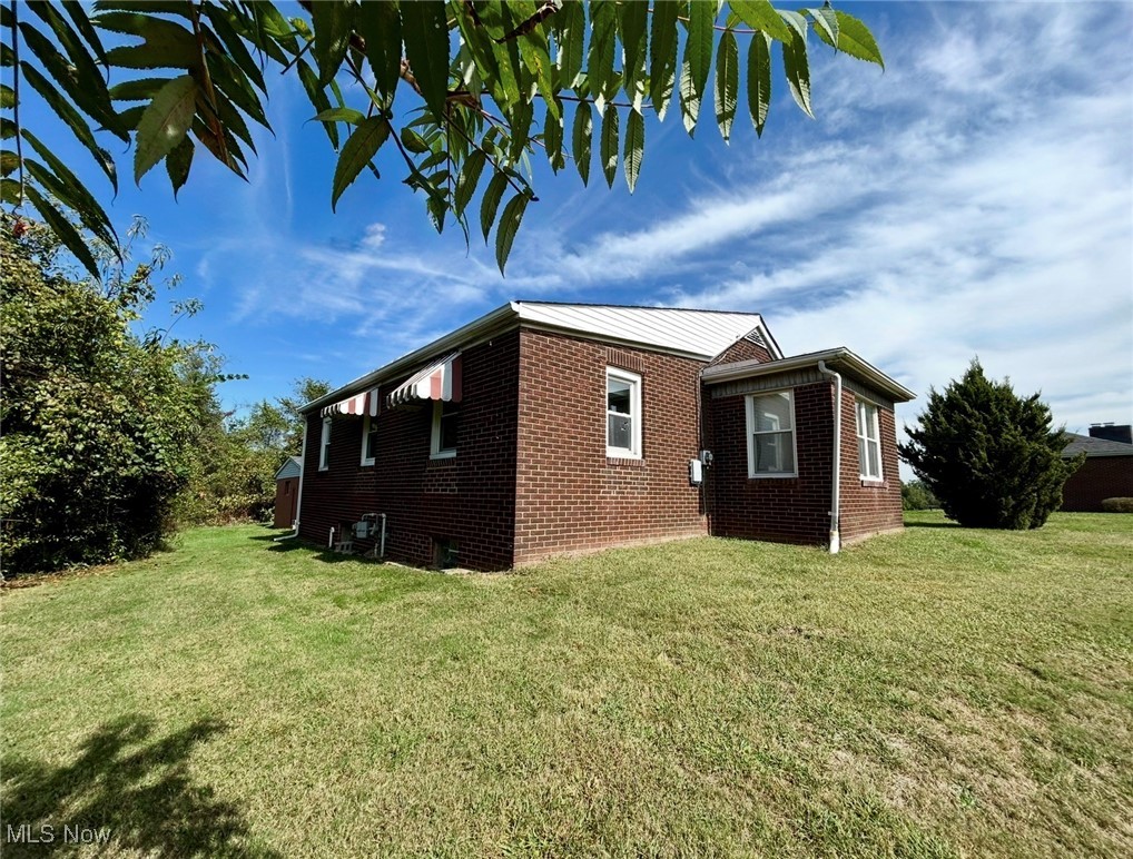164 Locust Lane Follansbee, WV 26037 - Photo 17 of 19 View of side of property featuring brick siding and a yard