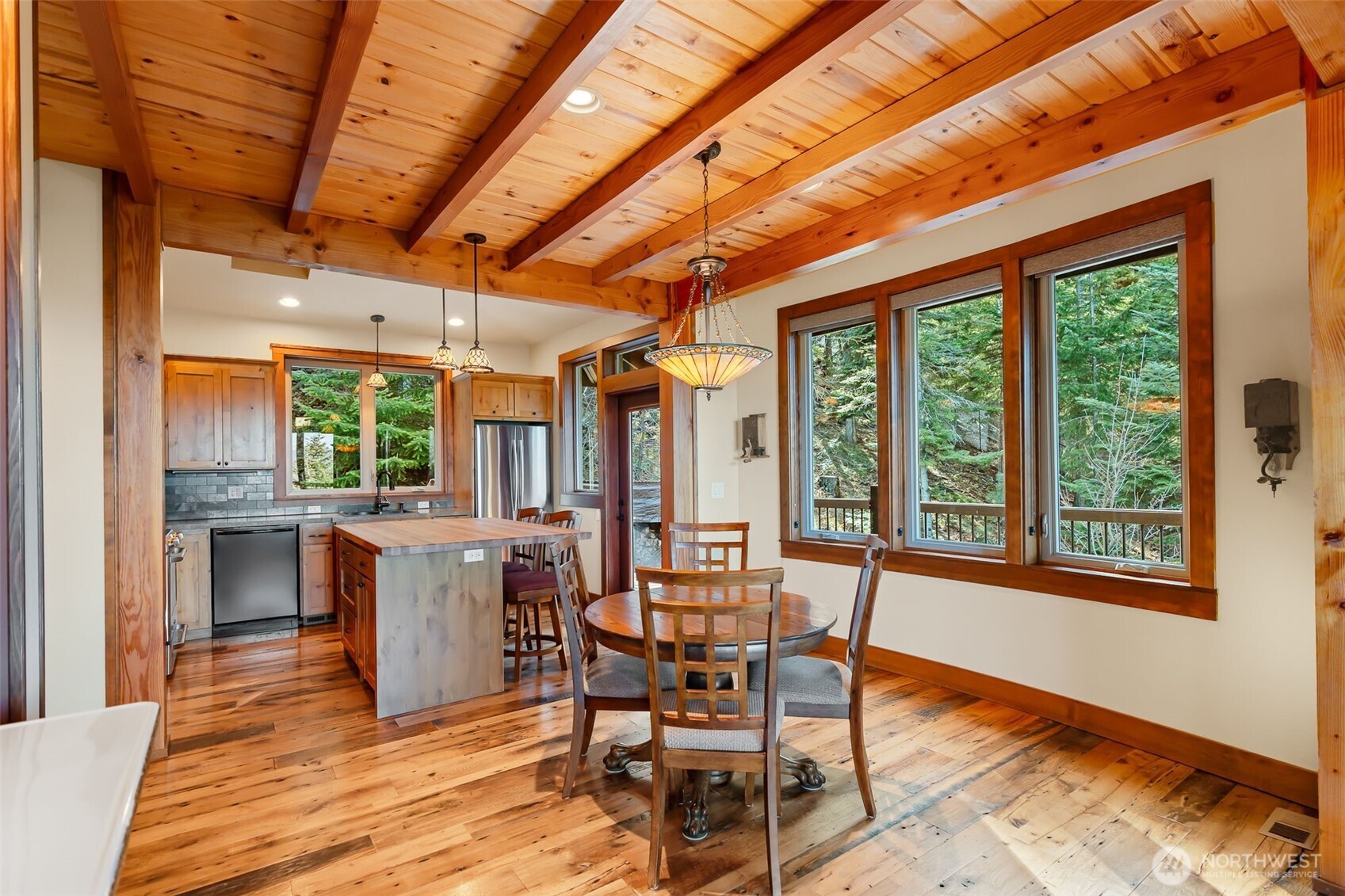 824 Huntrick Drive Cle Elum, WA 98922 - Photo 12 of 38 a dining room with furniture window wooden floor and a garden view