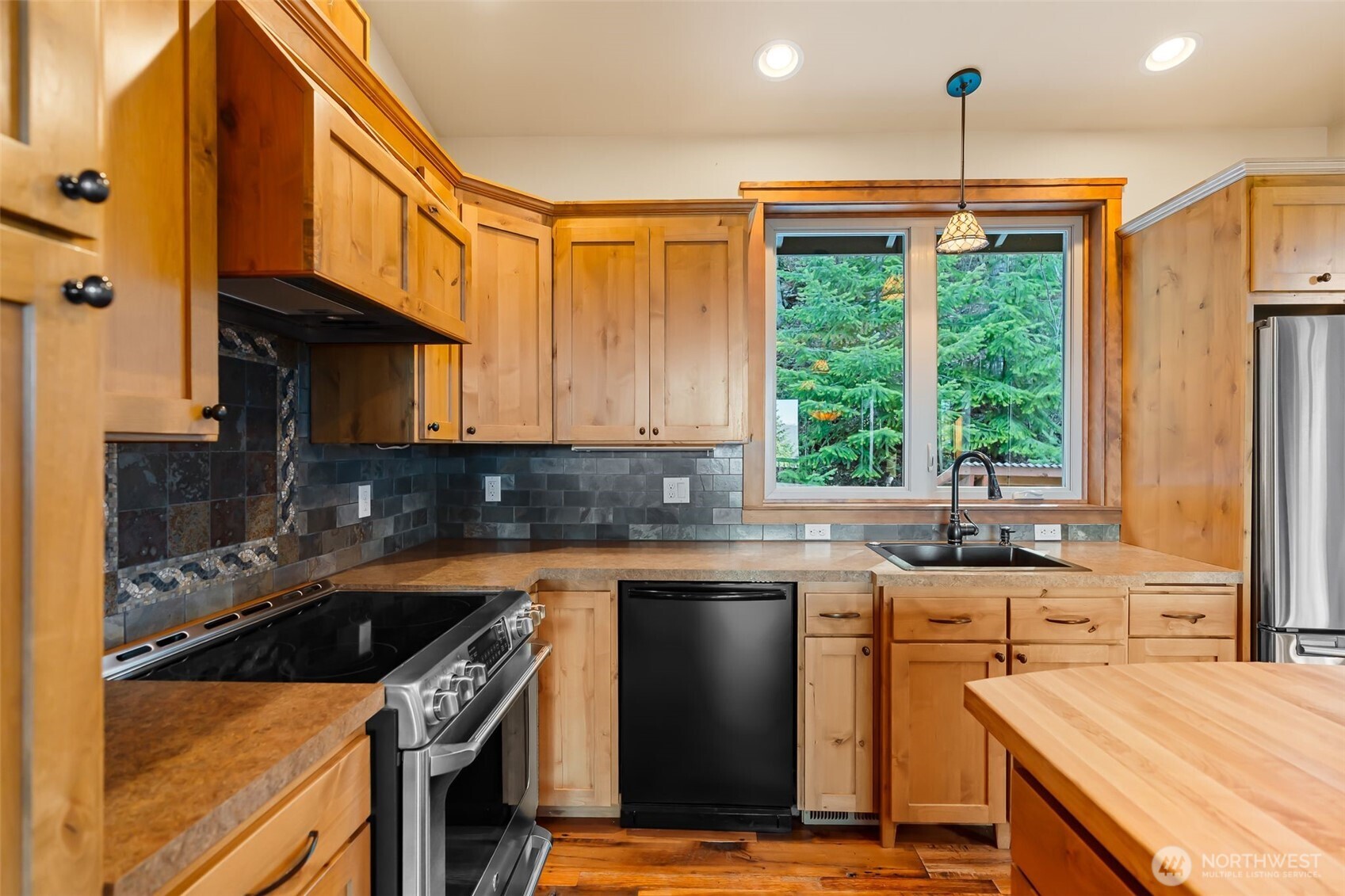 824 Huntrick Drive Cle Elum, WA 98922 - Photo 16 of 38 a kitchen with stainless steel appliances granite countertop a stove a sink and a refrigerator