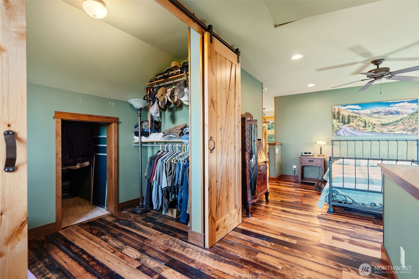 824 Huntrick Drive Cle Elum, WA 98922 - Photo 22 of 38 a view of a hallway with a couch and wooden floor