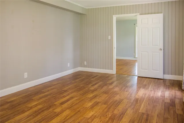 a view of an empty room and wooden floor
