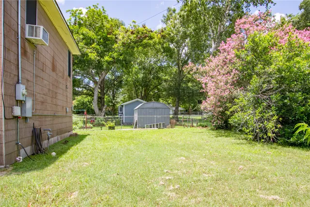 a yellow house with swimming pool in front of it