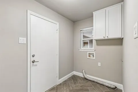 a view of storage and utility room with wooden floor