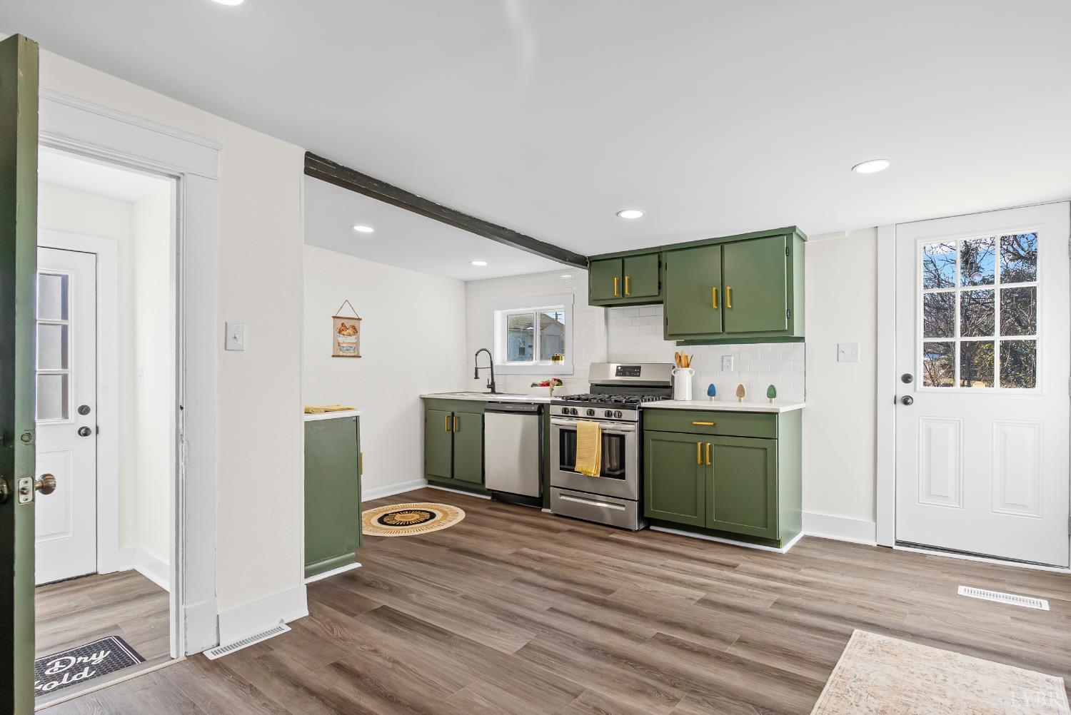 2961 Triangle Place Lynchburg, VA 24501 - Photo 13 of 26 a kitchen with stainless steel appliances kitchen island granite countertop a refrigerator oven a sink dishwasher and white cabinets with wooden floor