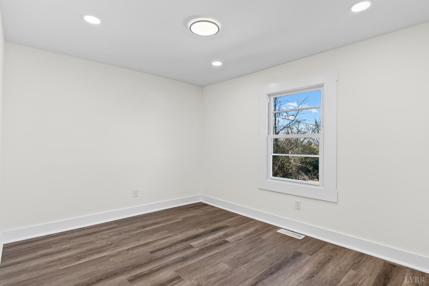 2961 Triangle Place Lynchburg, VA 24501 - Photo 8 of 26 an empty room with wooden floor and windows