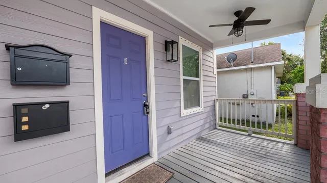 a view of a porch with wooden floor and a fireplace