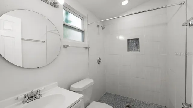 a bathroom with a toilet sink and shower