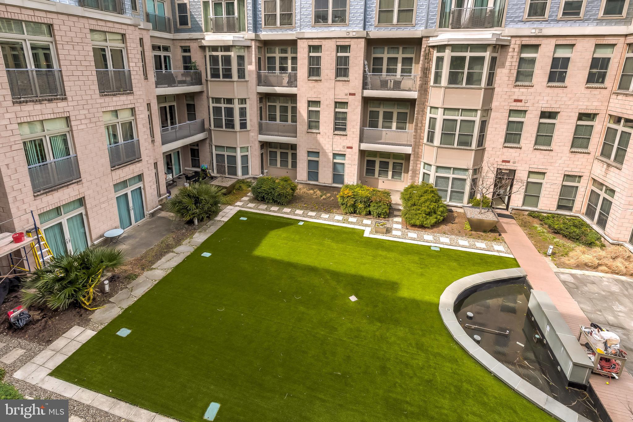 1209 North Charles Street, Unit 304 Baltimore, MD 21201 - Photo 27 of 37 a view of a swimming pool with a lounge chairs