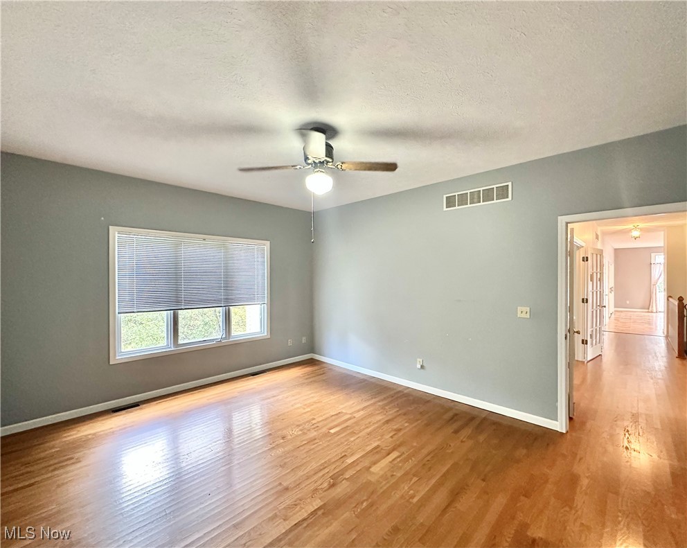 6047 Tallmadge Road Rootstown, OH 44272 - Photo 24 of 50 Primary bedroom with ceiling fan and hardwood floors