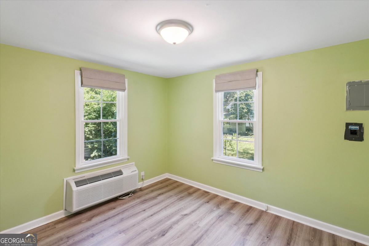 6326 N Highway Springfield, GA 31329 - Photo 11 of 14 a view of an empty room with wooden floor and a window