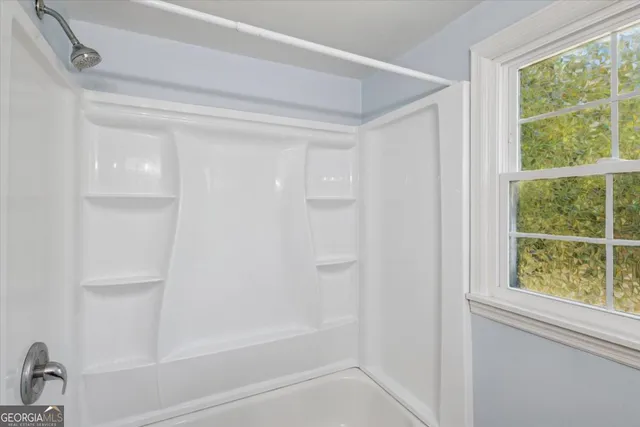 a view of a house with backyard and tree