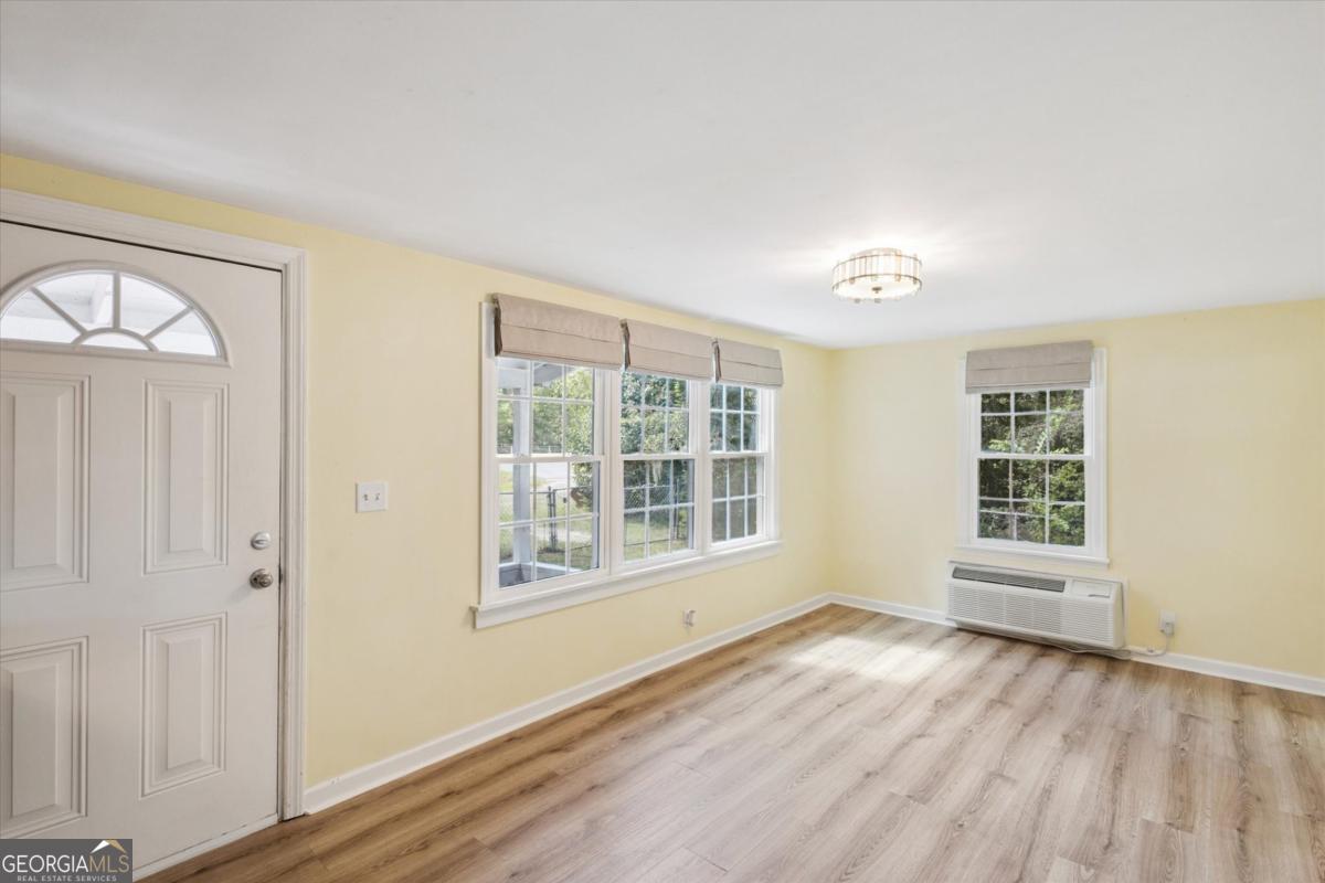 6326 N Highway Springfield, GA 31329 - Photo 2 of 14 a view of an empty room with a window and wooden floor