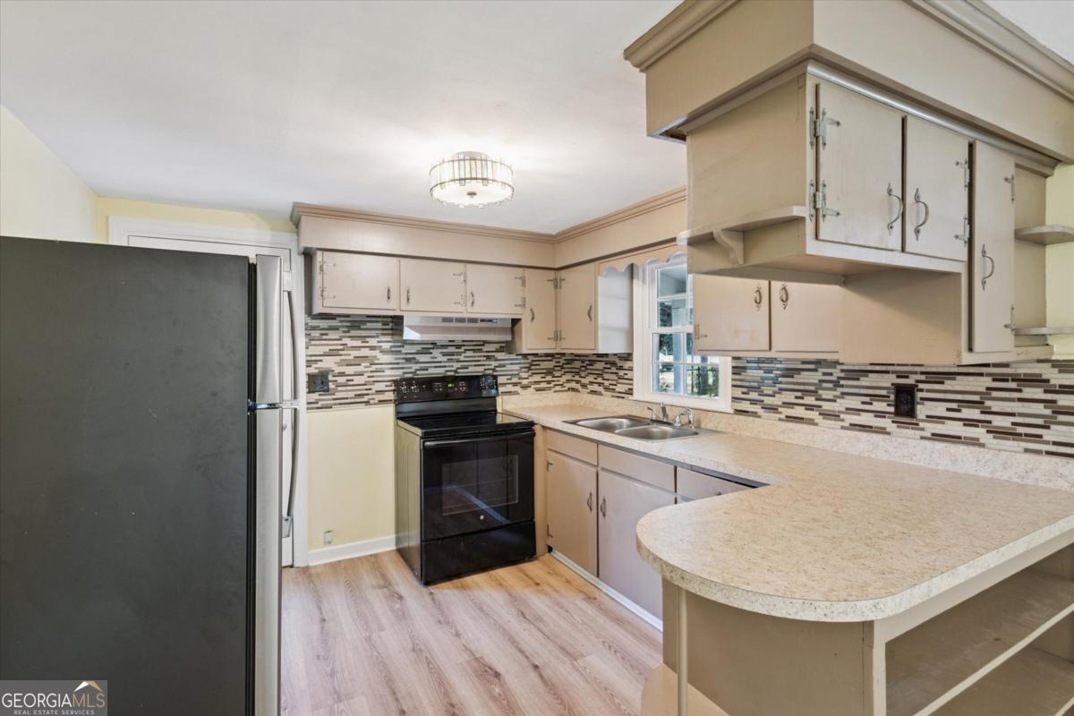 6326 N Highway Springfield, GA 31329 - Photo 4 of 14 a kitchen with stainless steel appliances granite countertop a sink stove and refrigerator