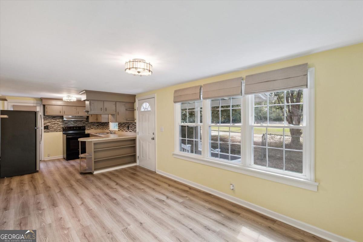 6326 N Highway Springfield, GA 31329 - Photo 5 of 14 a kitchen with granite countertop a refrigerator and wooden floor