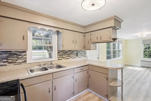 a kitchen with a sink cabinets and window
