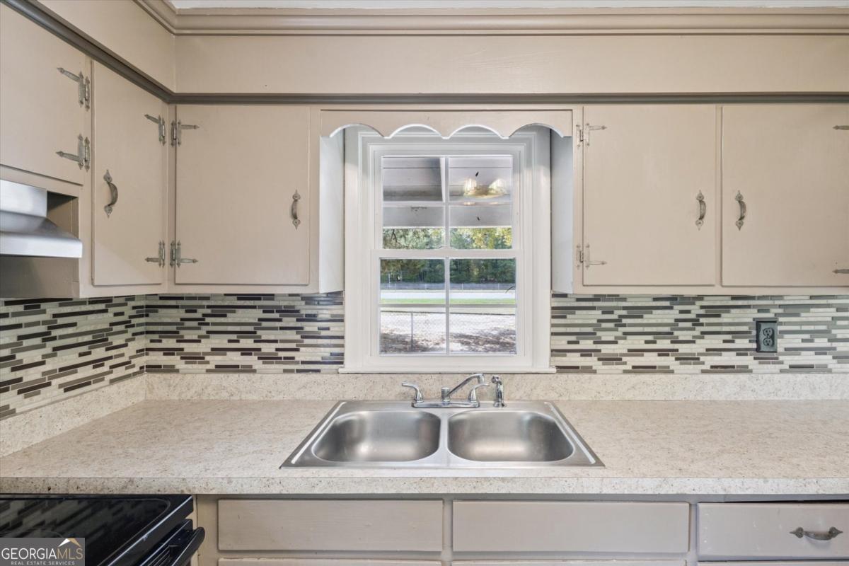 6326 N Highway Springfield, GA 31329 - Photo 7 of 14 a kitchen with a sink and a granite top
