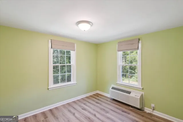 a view of a room with wooden floor and windows