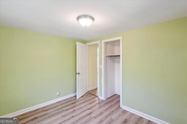 a view of room with wooden floor