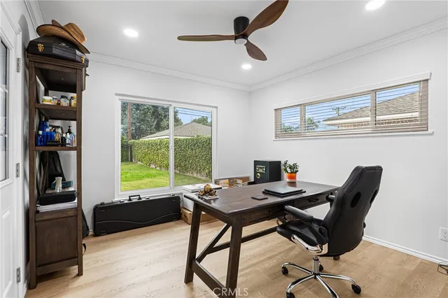 a view of a workspace with furniture and a window