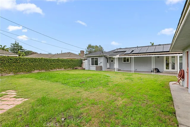 a view of a house with a backyard