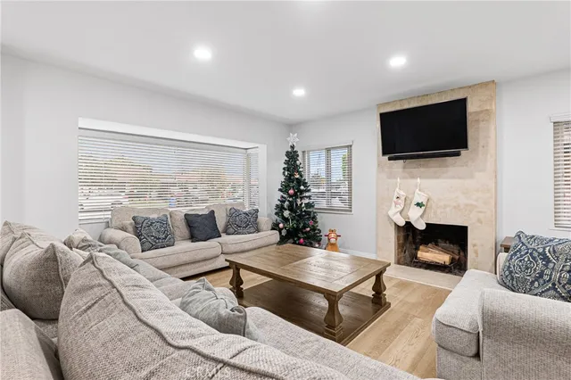 a living room with furniture a fireplace and a flat screen tv