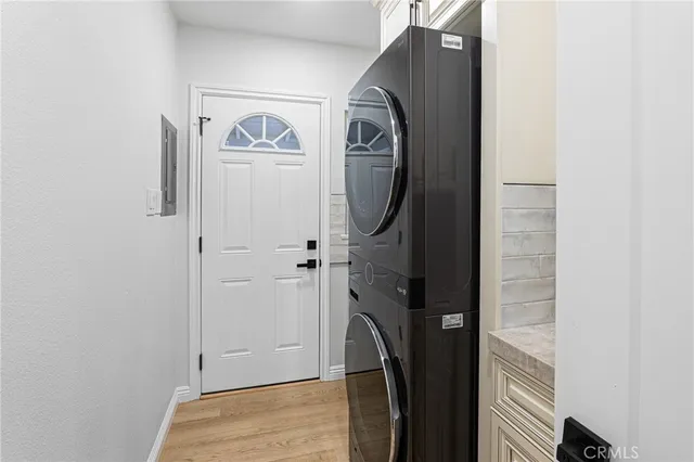 a view of a hallway with wooden floor and entryway