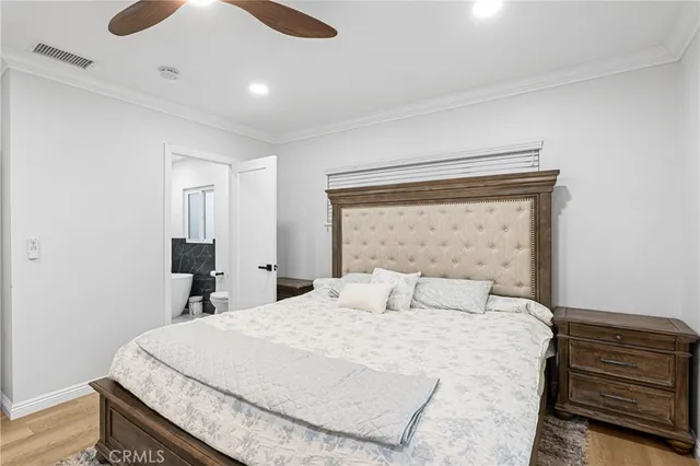 a bedroom with a bed and a night stand