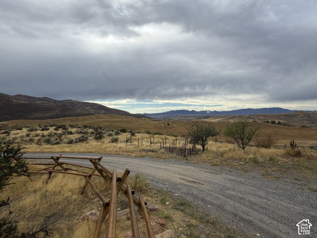 4458 East Glencoe Road Preston, ID 83263 - Photo 51 of 52 Gravel driveway with a split rail fence, expansive open terrain, and distant mountain ranges