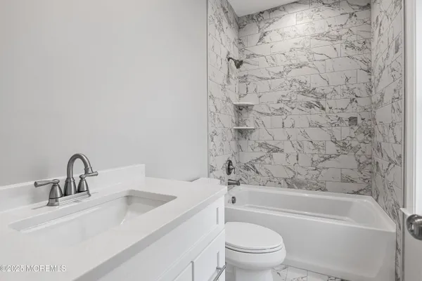 a bathroom with a sink a toilet and bathtub