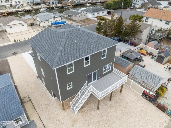 an aerial view of a house with swimming pool and outdoor seating