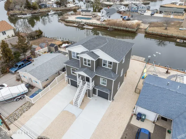 an aerial view of a house with lake view