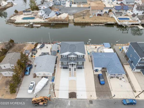 an aerial view of a house with outdoor seating