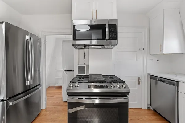 a kitchen with stainless steel appliances granite countertop a stove and a refrigerator