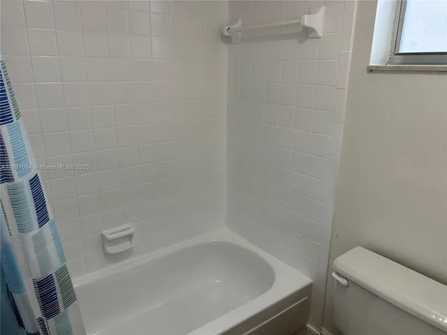 a bathroom with a bathtub and toilet