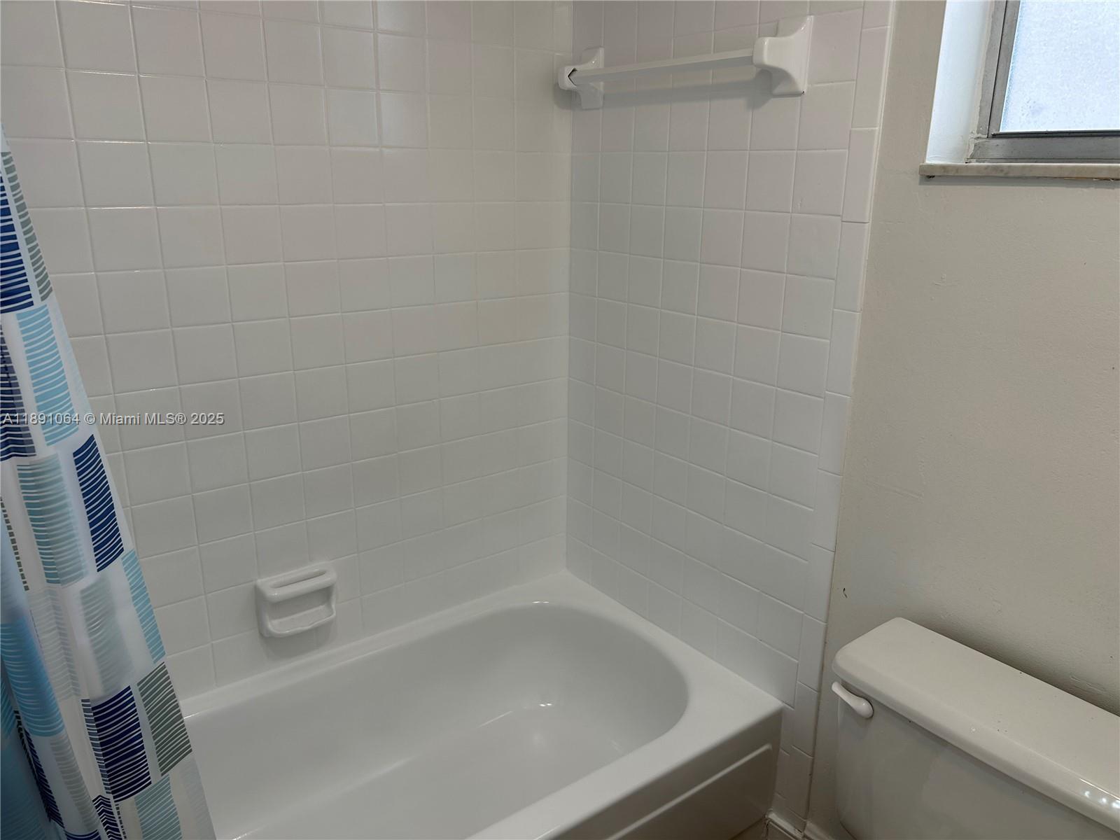 9430 Live Oak Place, Unit 404 Davie, FL 33324 - Photo 15 of 28 a bathroom with a bathtub and toilet