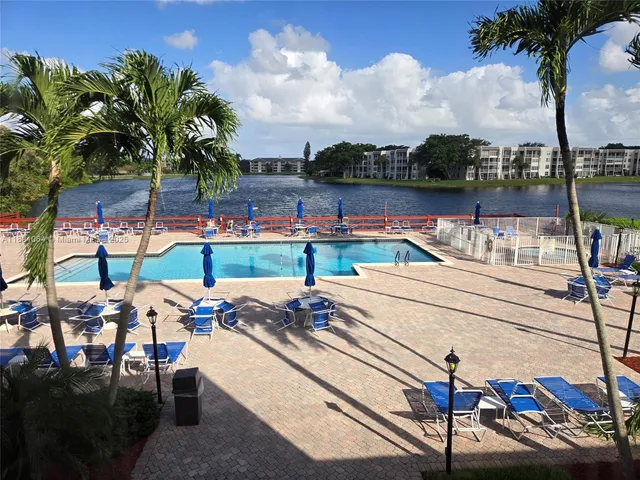 a view of a lake with couches chairs