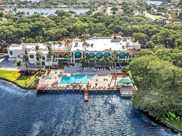 an aerial view of a house with swimming pool and patio