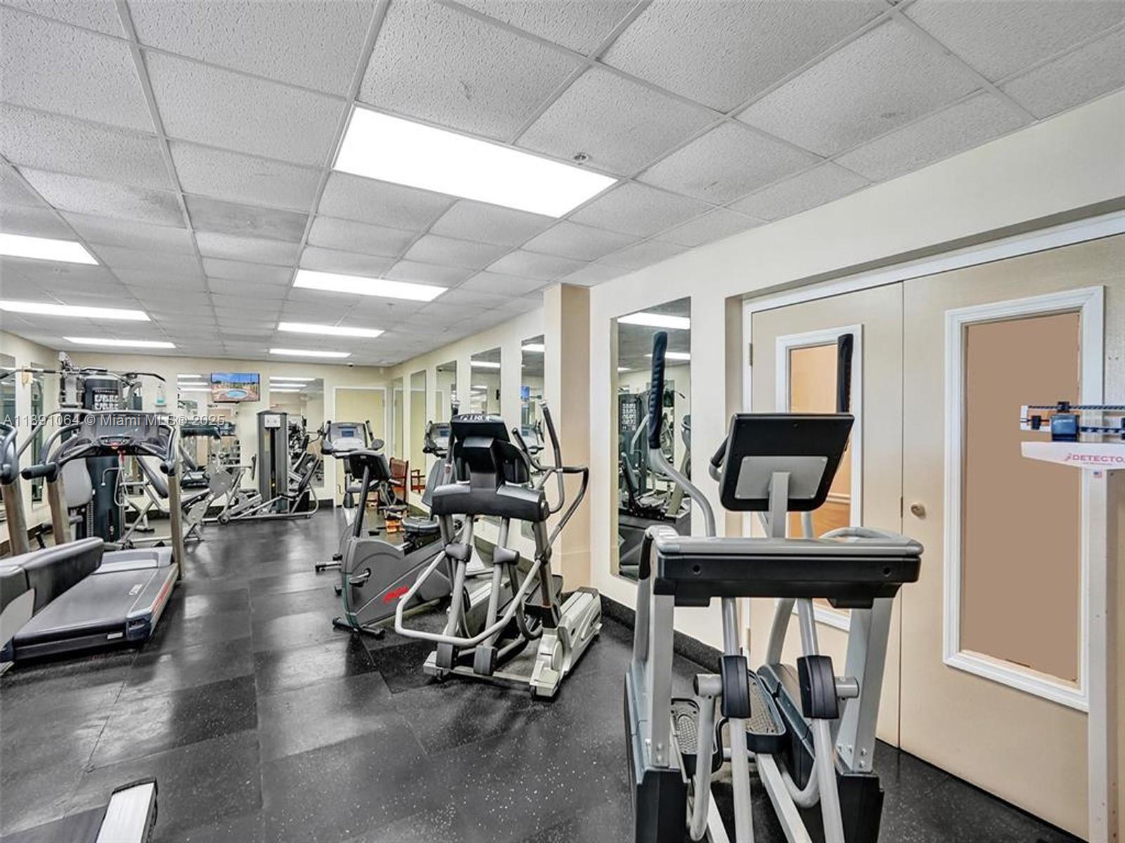 9430 Live Oak Place, Unit 404 Davie, FL 33324 - Photo 22 of 28 a view of a room with lots of chairs and a chandelier
