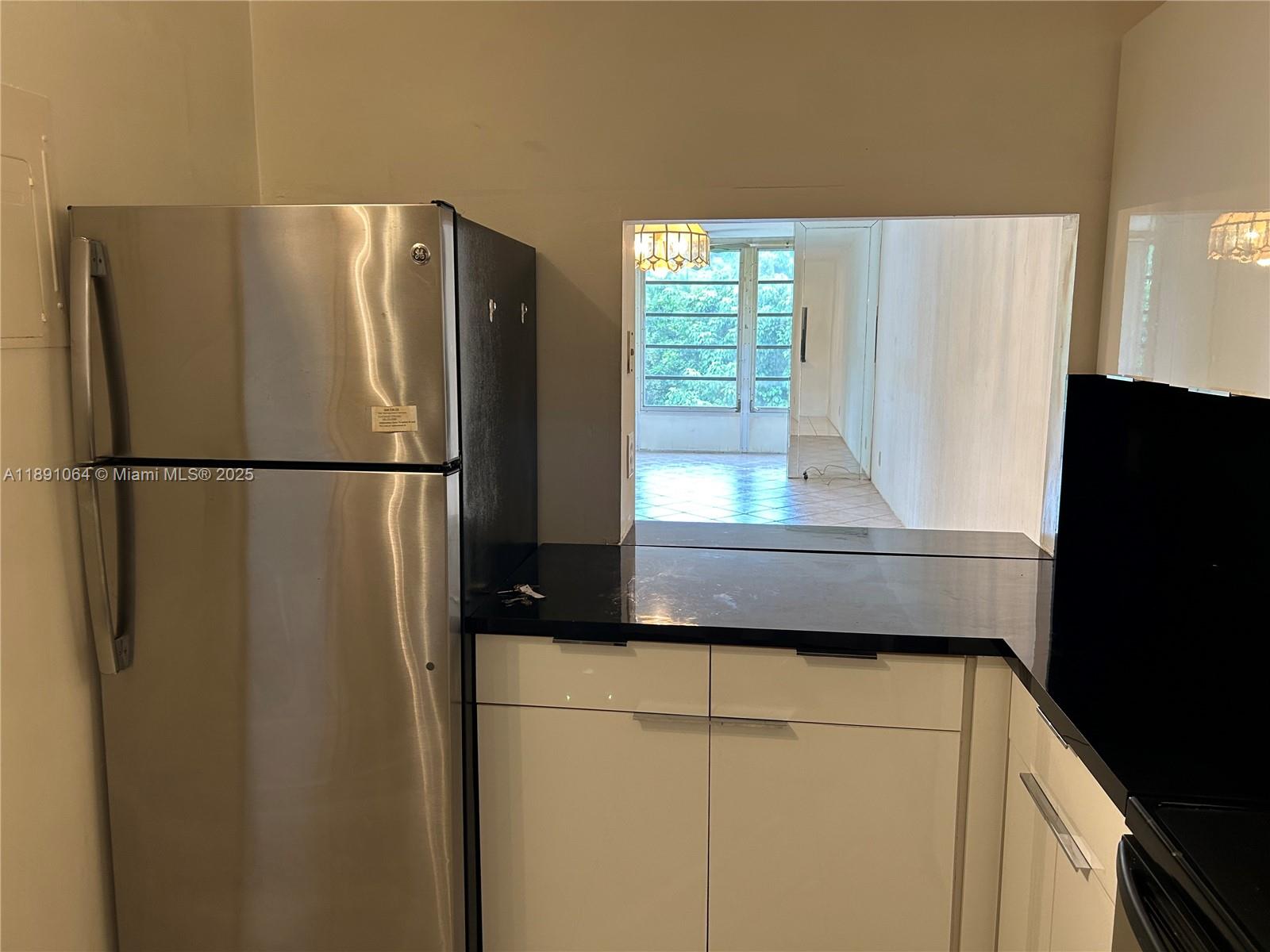 9430 Live Oak Place, Unit 404 Davie, FL 33324 - Photo 4 of 28 a kitchen with a refrigerator and window