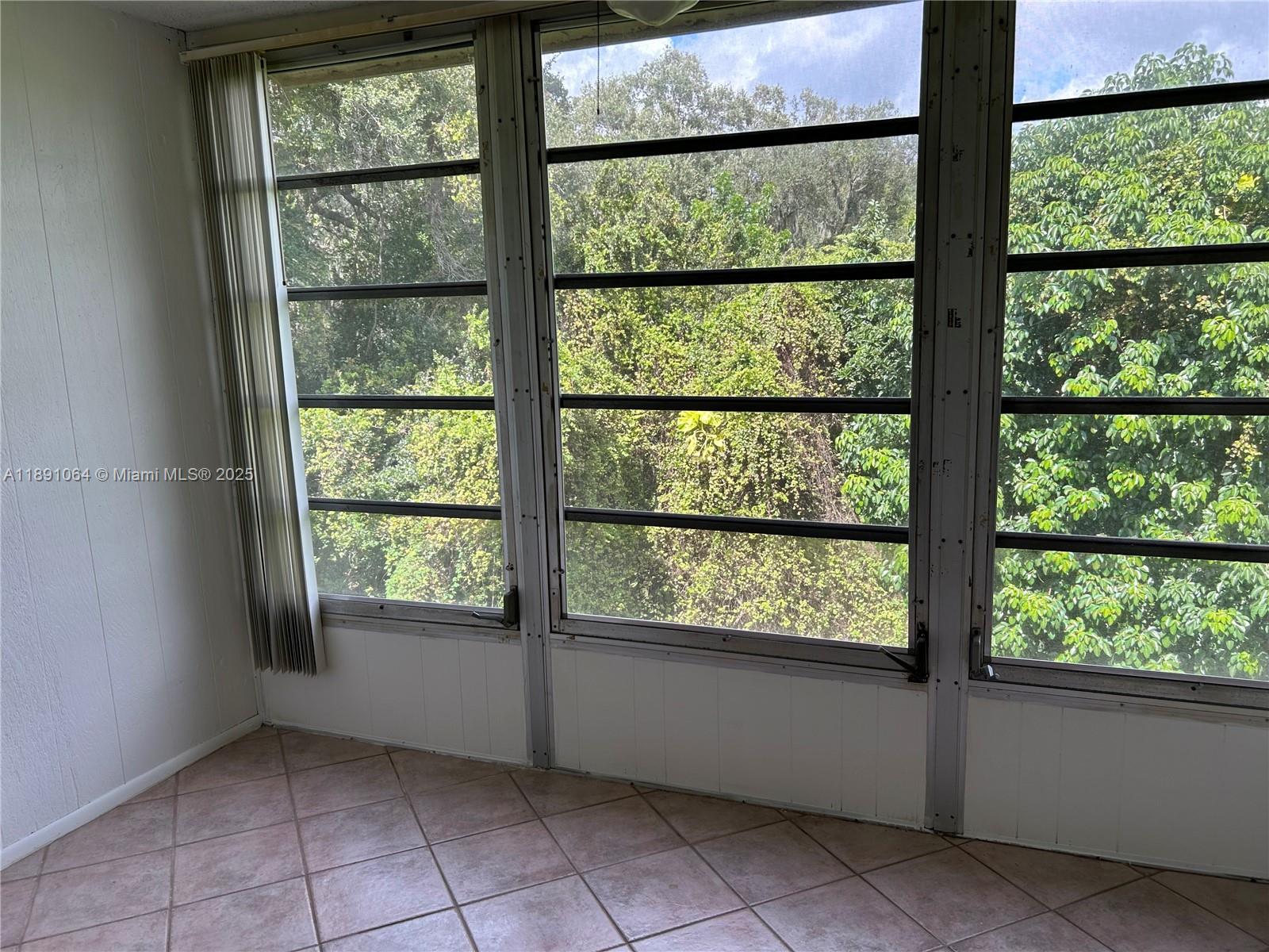 9430 Live Oak Place, Unit 404 Davie, FL 33324 - Photo 6 of 28 an empty room with large windows