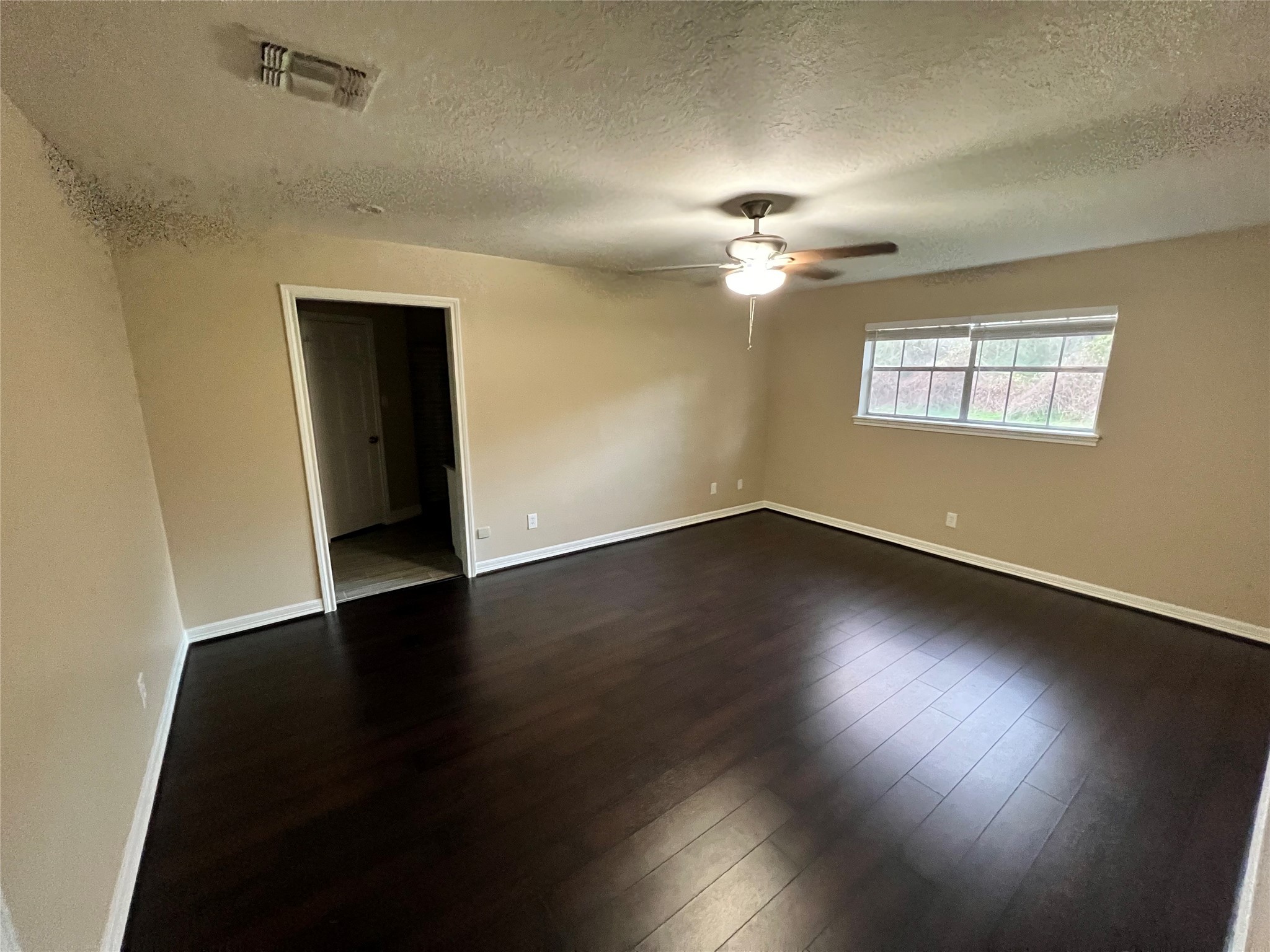 18240 Fenske Road Cypress, TX 77433 - Photo 17 of 20 an empty room with wooden floor and windows