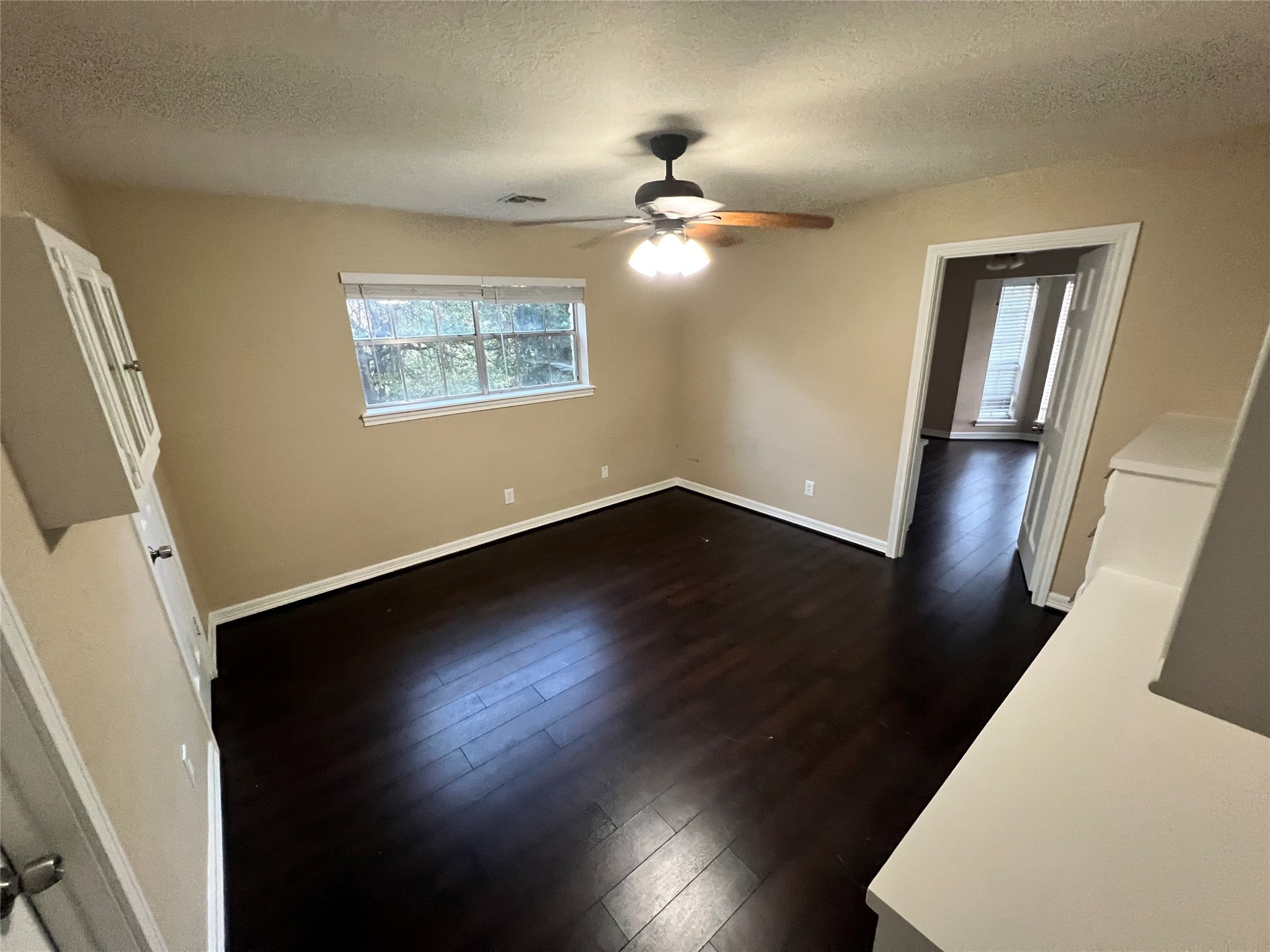 18240 Fenske Road Cypress, TX 77433 - Photo 7 of 20 a view of an empty room with wooden floor and a window