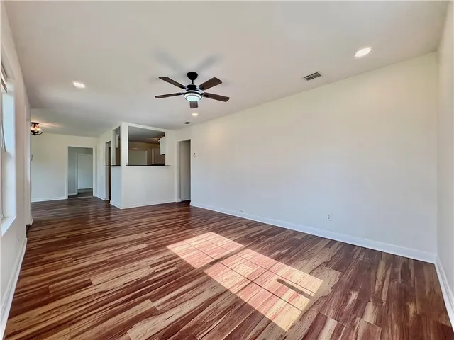 a view of an empty room and wooden floor