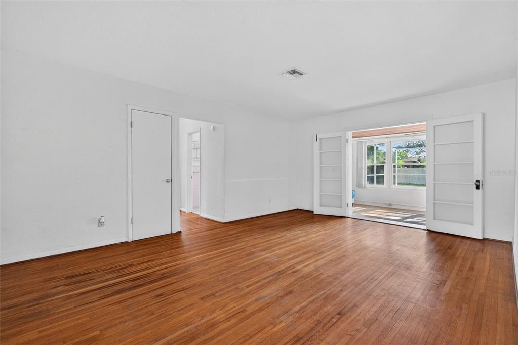 1739 Turner Street Clearwater, FL 33756 - Photo 13 of 72 a view of an empty room with wooden floor and window