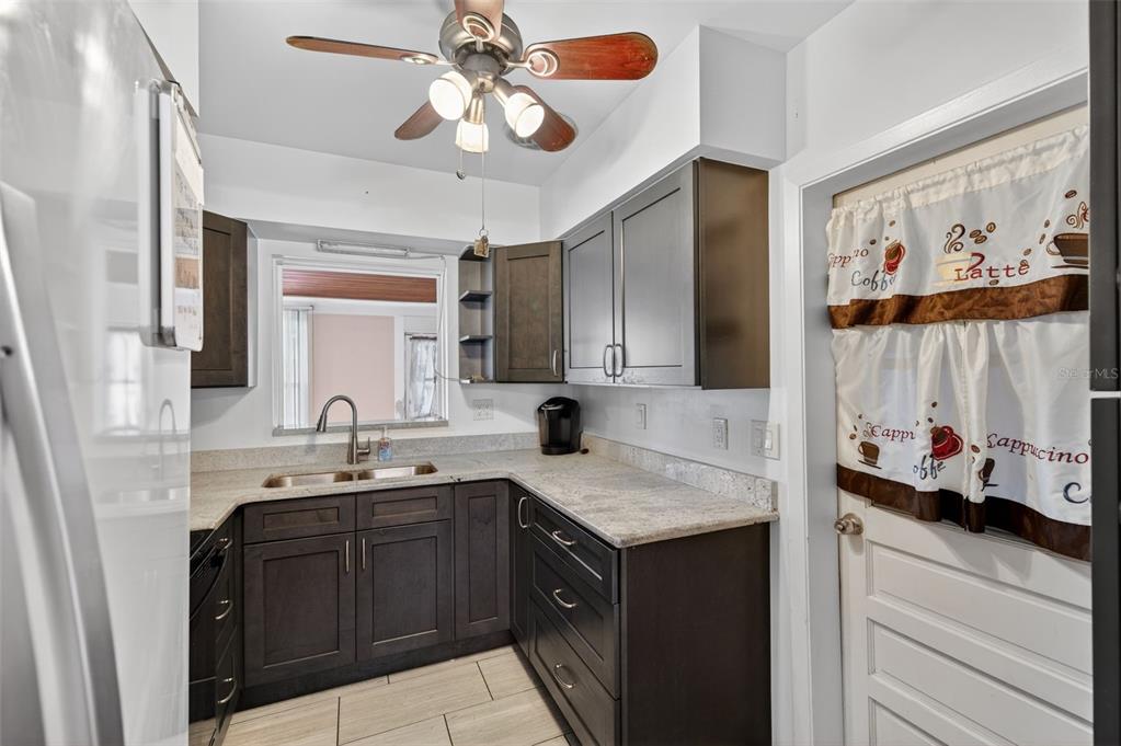 1739 Turner Street Clearwater, FL 33756 - Photo 20 of 72 a kitchen with a sink dishwasher a stove a microwave oven with cabinets and wooden floor