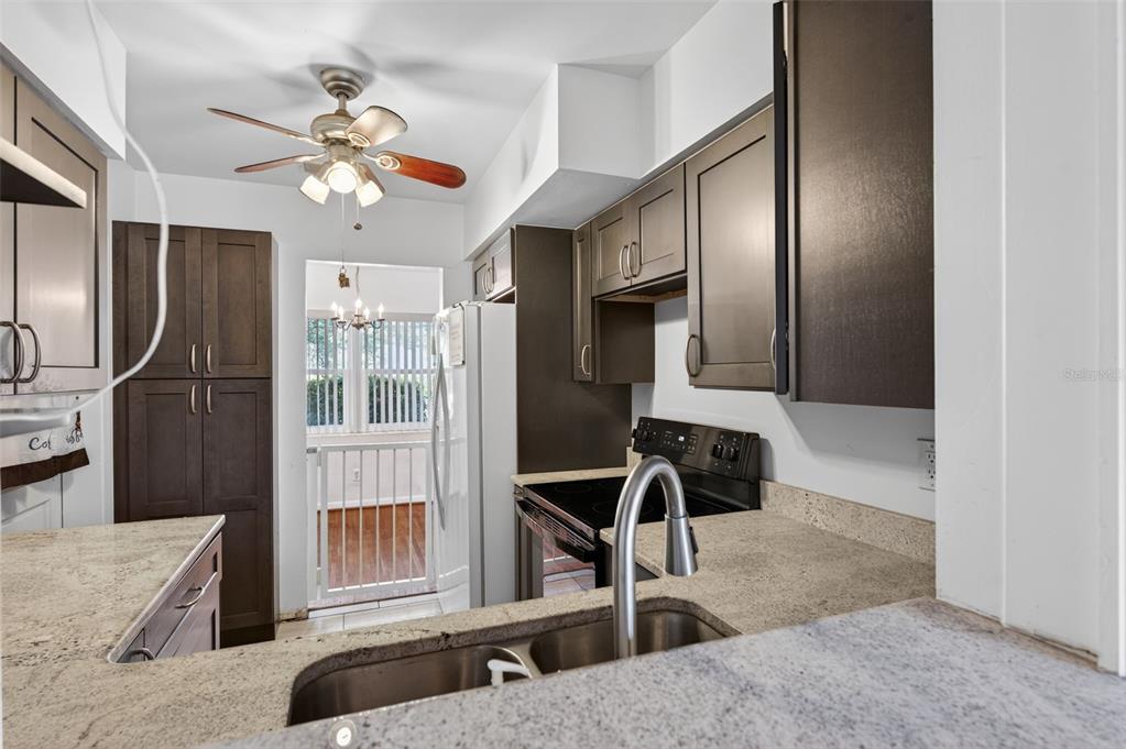 1739 Turner Street Clearwater, FL 33756 - Photo 26 of 72 a kitchen with stainless steel appliances kitchen island granite countertop a refrigerator and a sink