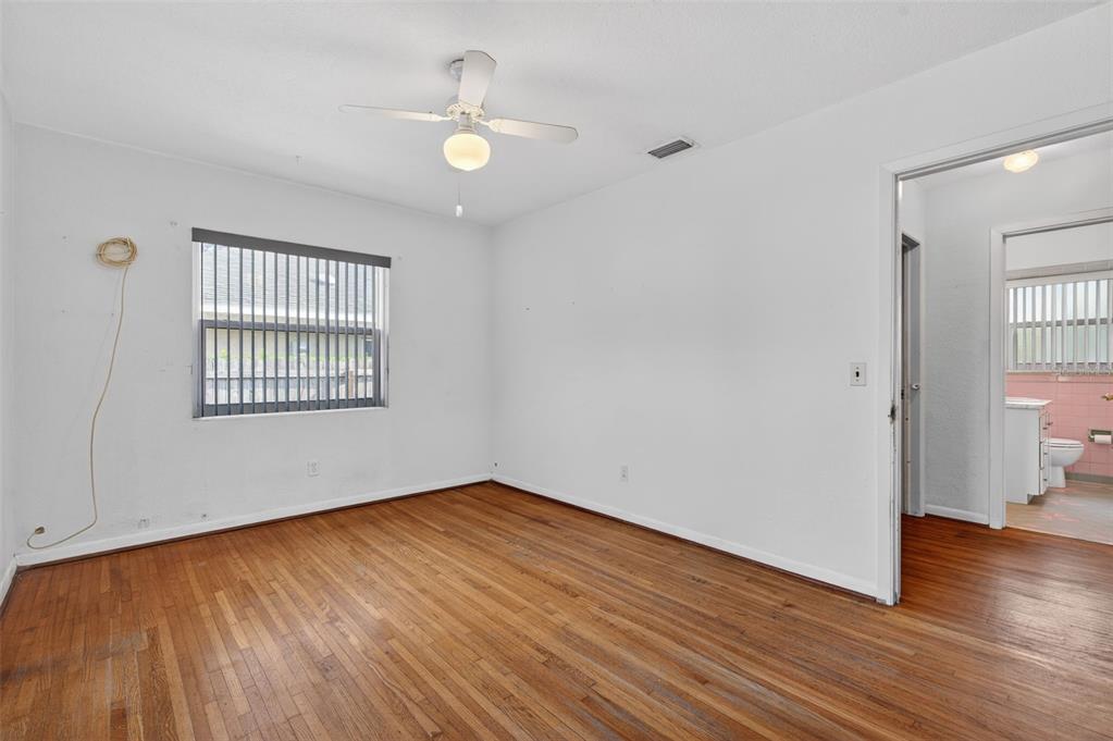 1739 Turner Street Clearwater, FL 33756 - Photo 39 of 72 an empty room with wooden floor cabinet and windows