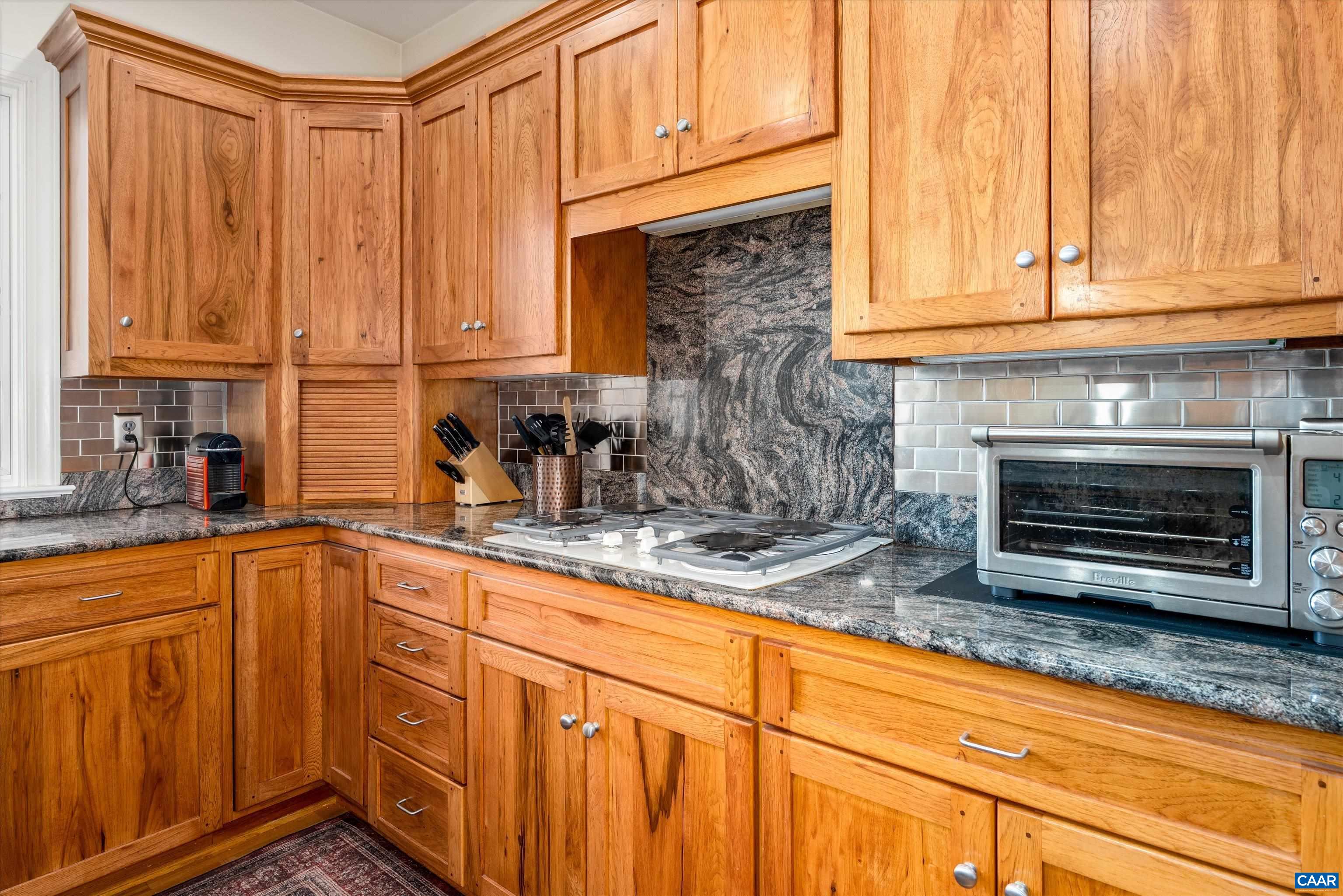 4444 Woods Edge Road Troy, VA 22974 - Photo 27 of 74 a kitchen with stainless steel appliances granite countertop a sink a stove and cabinets