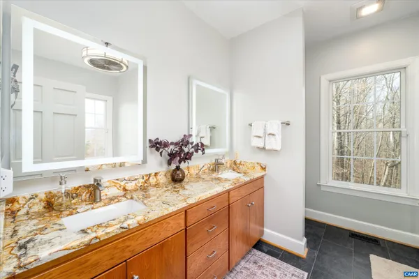 a bathroom with a shower and a glass door